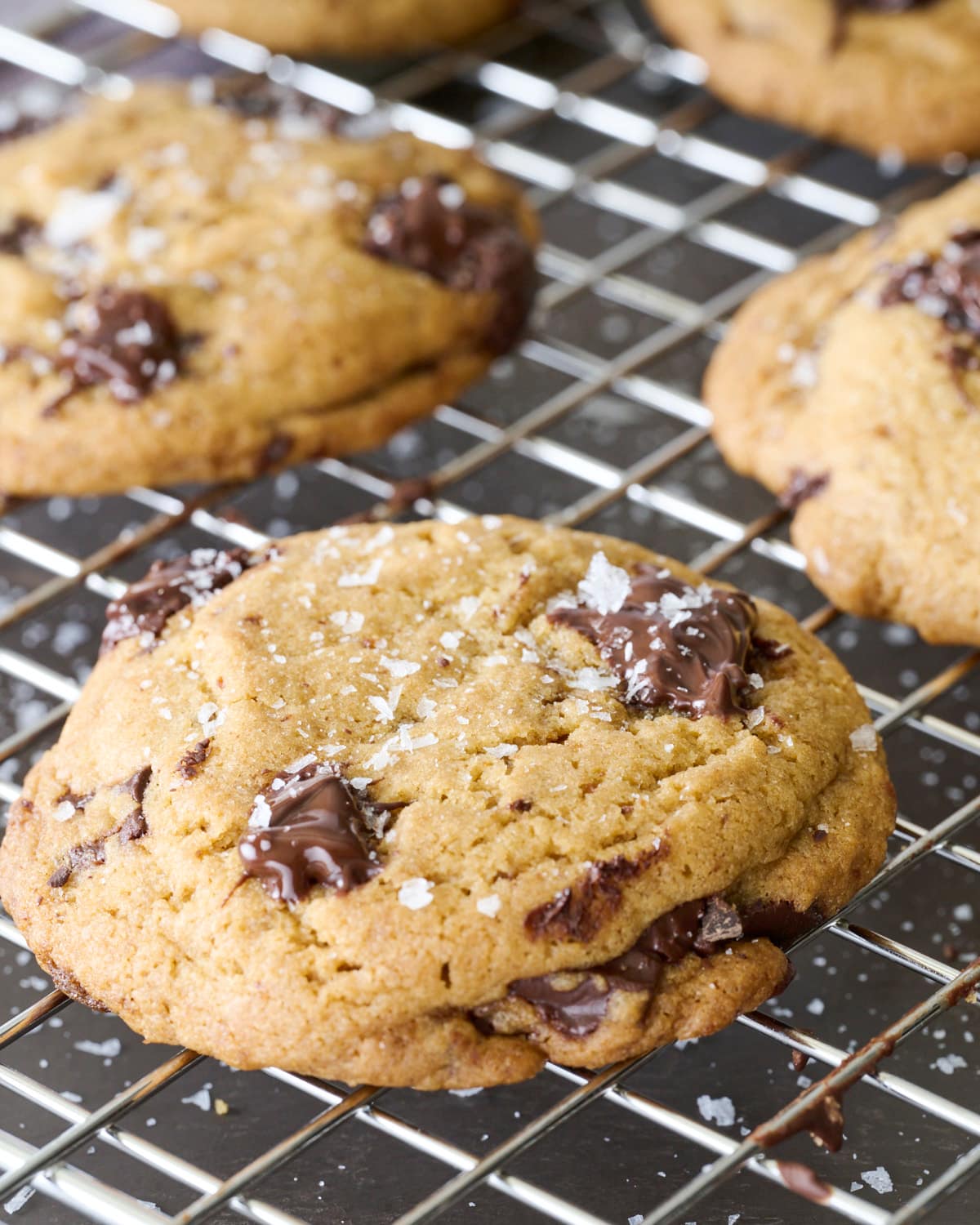 Thick Brown Butter Chocolate Chunk Cookie with melted chocolate chunks and crisp edges resting on a cooling rack.